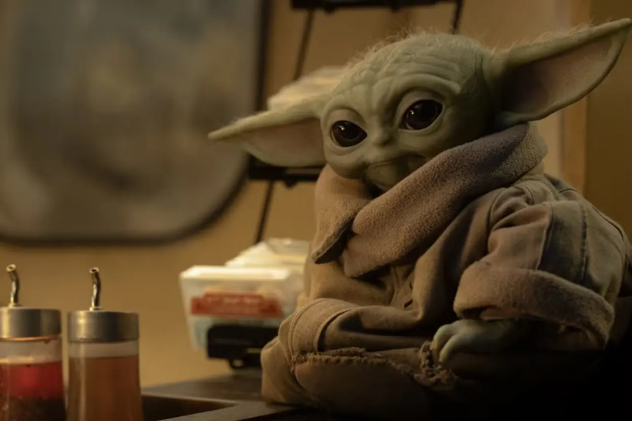 Grogu sits by some sauce dispensers in The Mandalorian and Grogu
