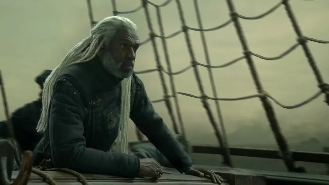 Corlys Velaryon (Steve Toussaint) stands near the rigging of a ship in House of the Dragon