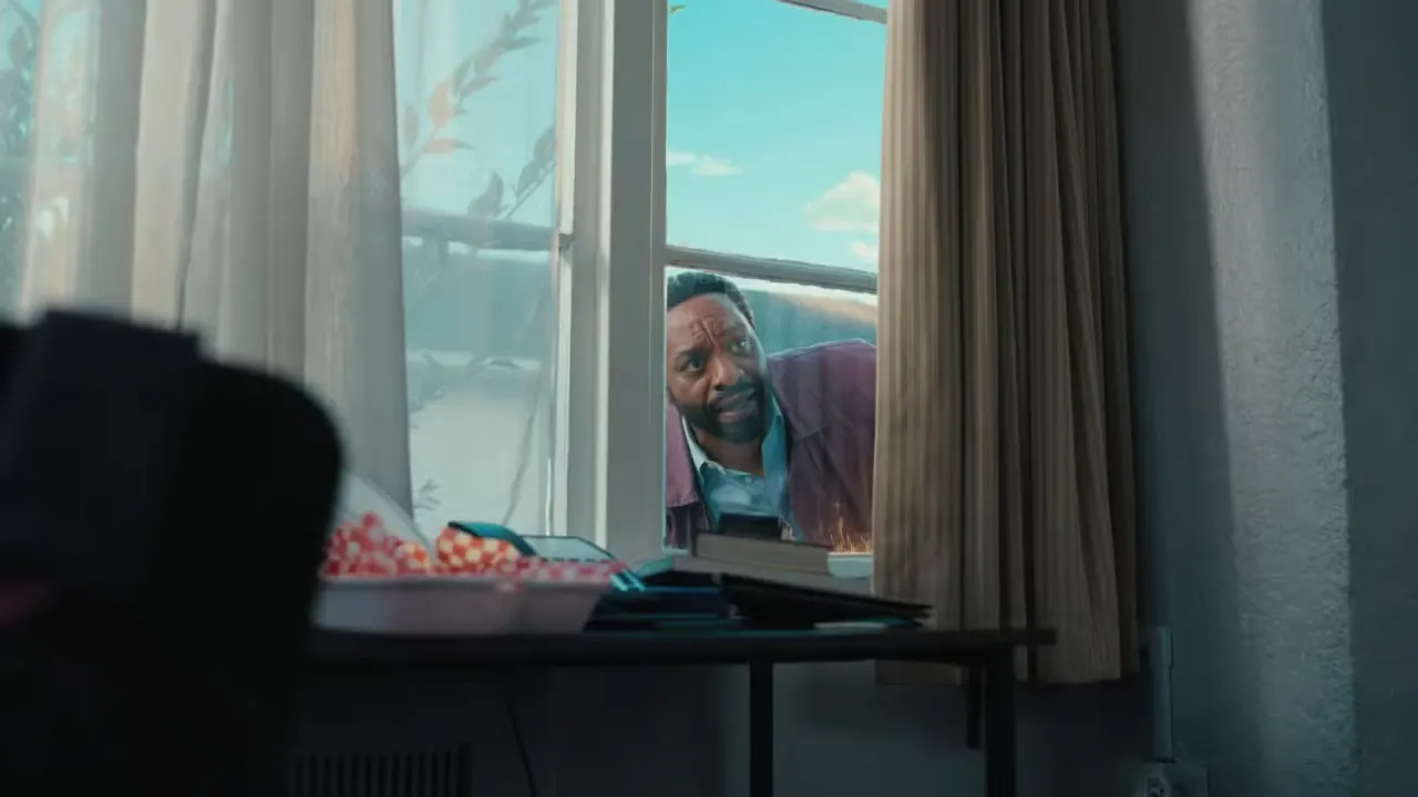 Clark (Chiwetel Ejiofor) peers through the curtained window of a house in Backrooms