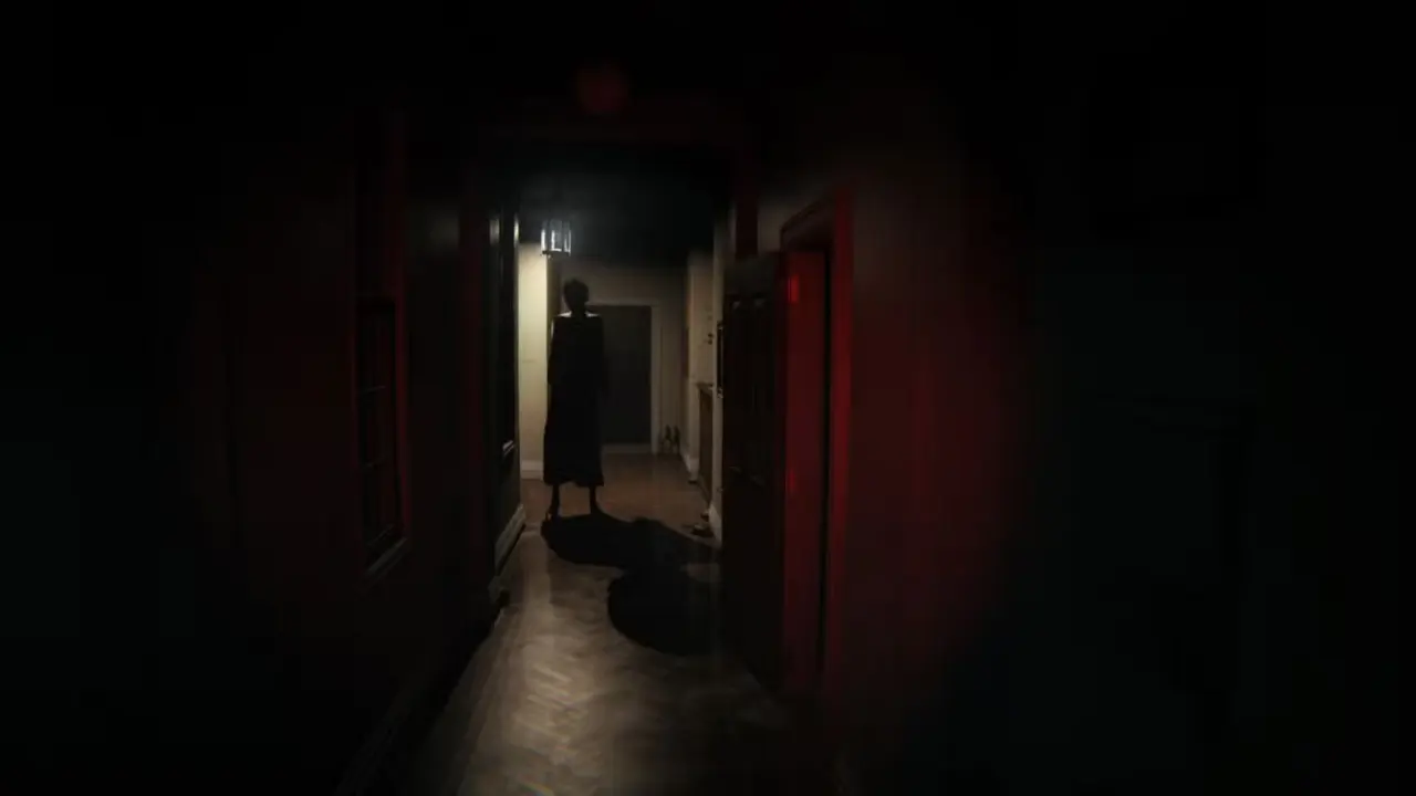 P.T.’s ghost, Lisa, stands in a dark hallway